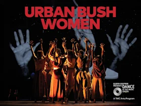 A group of dancers stand with raised arms under the text "Urban Bush Women." In the background, large projected hands are visible.
