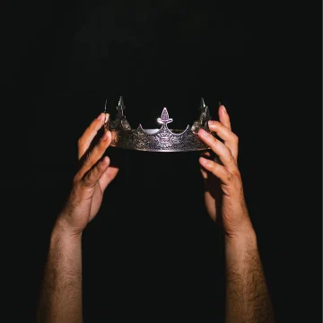 Production shot of Hamlet in Chicago showing a man holding a crown.