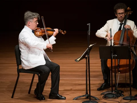 Production shot of The Chamber Music Society of Lincoln Center: Summer Evenings VI in New York, with Violinist Aaron Boyd and cellists Nicholas Canellakis.