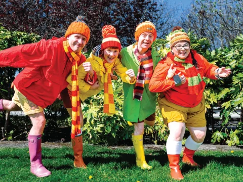 Production shot of Four Go Wild in Wellies in New York, showing ensemble with their colorful winter clothing.