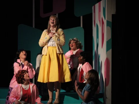 Production photo of Grease in Illinois with Olivia Daly-Short as Sandy and the Pink Ladies.