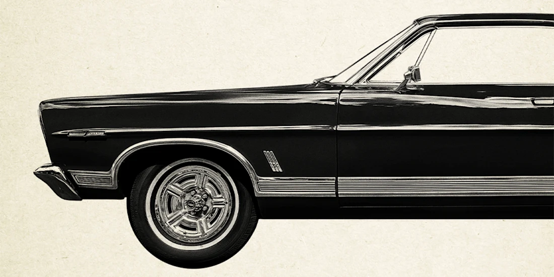 Black and white image of the front half of a classic car, shown from the side against a plain background.