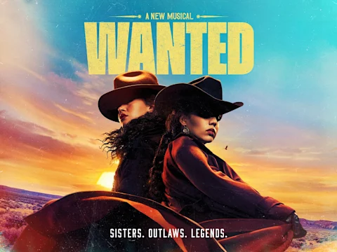 Two women in cowboy hats stand back to back in a western landscape at sunset. Text reads "WANTED: A New Musical. Sisters. Outlaws. Legends.