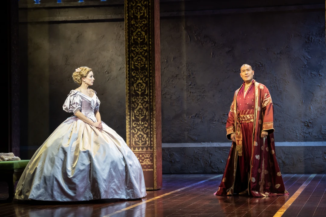 Production shot of The King and I in London, with Helen George as Anna Leonowens and Darren Lee as King of Siam.