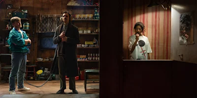 Two men stand in a cluttered shop using a corded phone, while a woman in a striped booth listens on a headset and looks into a mirror.