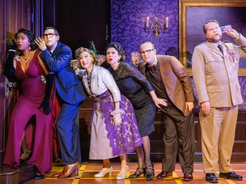 Production shot of Clue in Washington DC, showing ensemble posing for a photo.