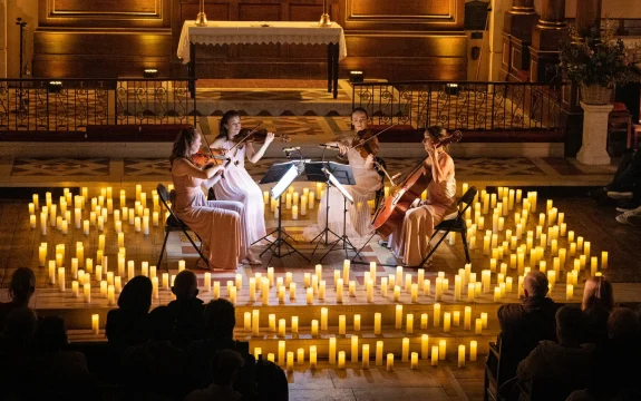 Production shot of Musicals by Candlelight in London showing ensembles playing violin.