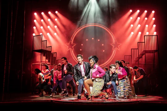 Production shot of Grease the Musical in London, with Dan Partridge as Danny and Jocasta Almgill as Rizzo.