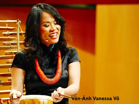 Vân-Ánh Vanessa Võ playing a percussion instrument on stage.