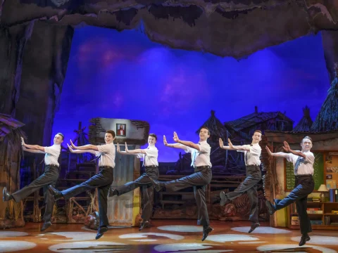 Production shot of The Book of Mormon in London featuring the 'Mormons' ensemble.