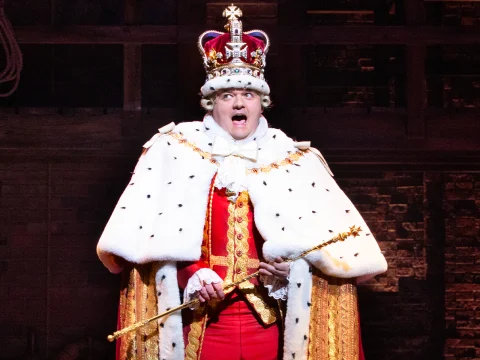 Production shot of Hamilton in London, with Michael Jibson as King George.