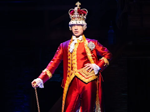 Production shot of Hamilton in London, with Michael Jibson as King George.