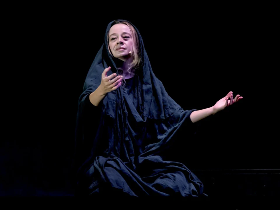 Production shot of Magdalene: I am the utterance of my name in New York, with Magdalene dressed in black robes.