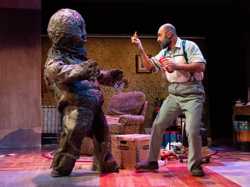 Production photo of The Hatmaker's Wife in Washington, DC with Tyler Herman and Maboud Ebrahimzadeh in a tattered monster costume.