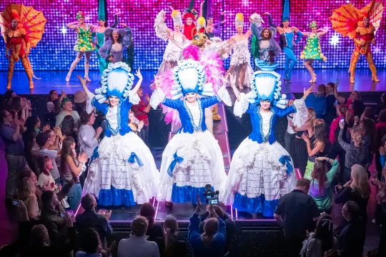 Production image of Priscilla the Party in London featuring full ensemble cast