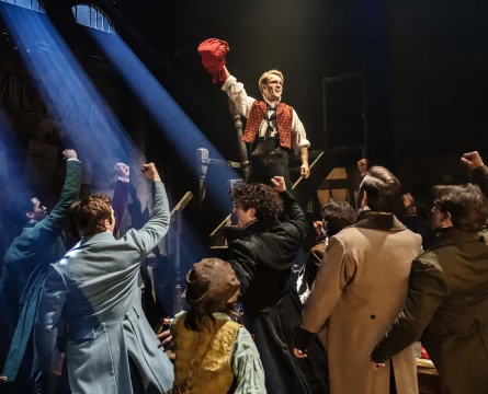 Production shot of Les Misérables in London, showing determination to fight for justice.