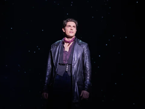 Production shot of Moulin Rouge in New York, with Derek Klena as Christian.