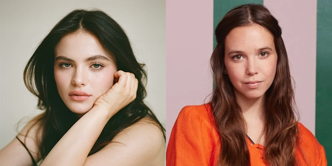 Two women with long dark hair; the woman on the left wears an orange top and stands against a striped background, while the woman on the right rests her head on her hand against a plain background.