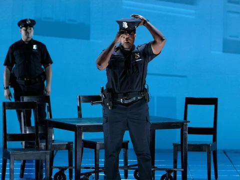 Production photo of Blue in Chicago showing two police officers in uniform are on a stage.