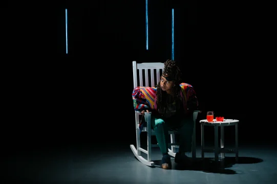 A woman sitting in a rocking chair.