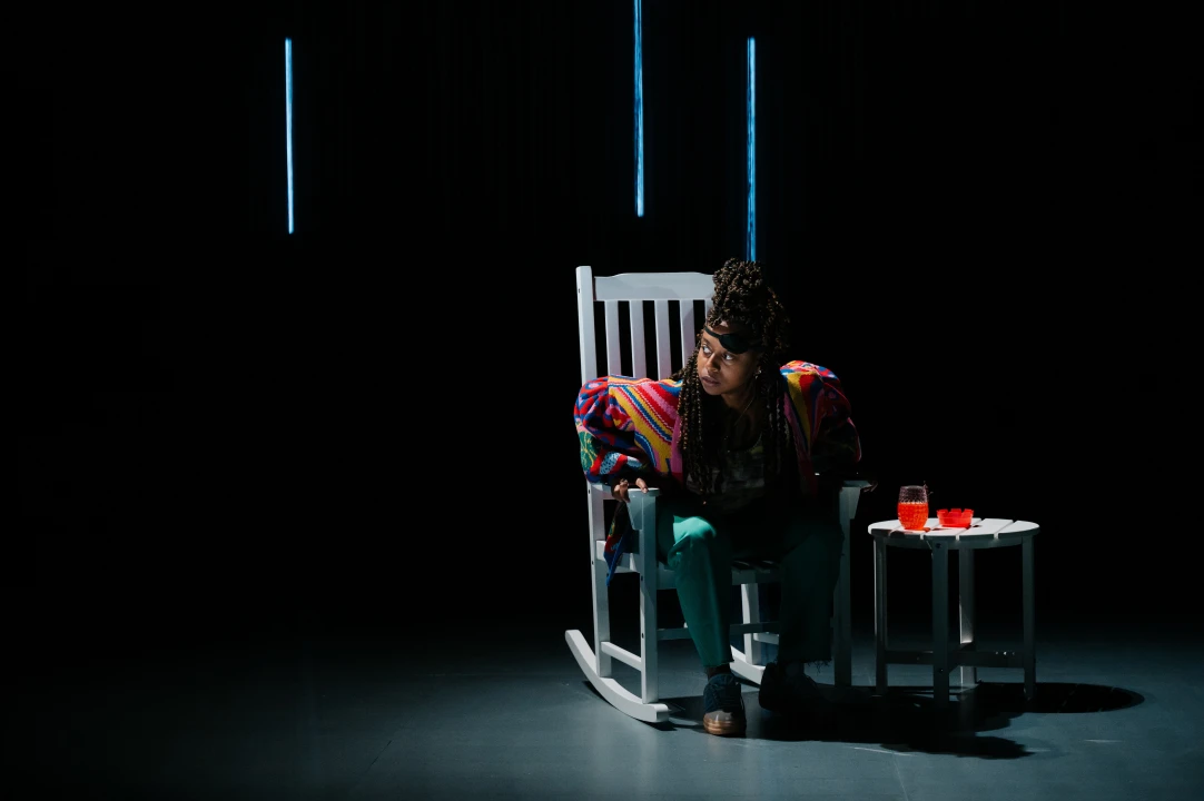 A woman sitting in a rocking chair.