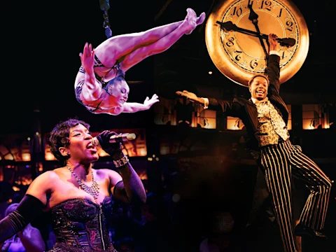 An acrobat performs a suspended pose on aerial straps in a red-lit setting.