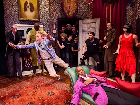 Production shot of The Play That Goes Wrong in London, featuring Jordan Akkaya as Trevor.