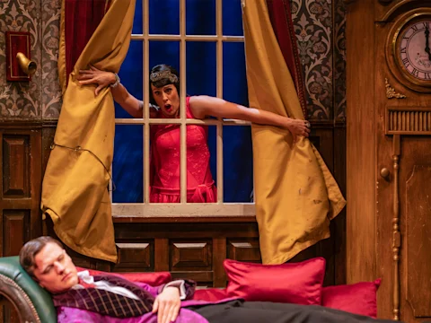 Production shot of The Play That Goes Wrong in London, featuring Jordan Akkaya as Trevor.