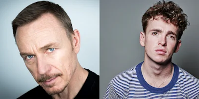 Two men are pictured side by side; the man on the left has short hair, a mustache, and wears black, while the man on the right has curly hair and wears a striped shirt.