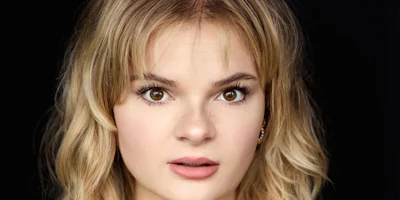 A headshot of a woman with blonde hair looking directly at the camera.