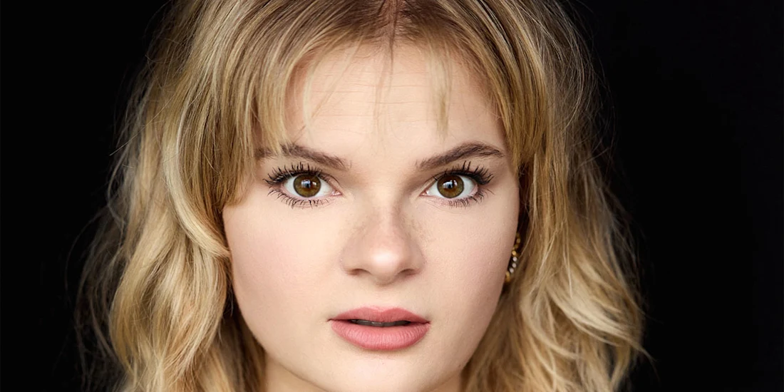 A headshot of a woman with blonde hair looking directly at the camera.