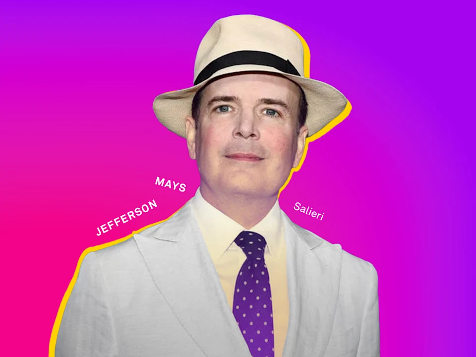 Photo of Jefferson Mays in a light suit, polka dot tie, and cream fedora stands against a pink and purple gradient background.