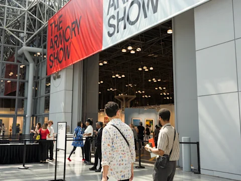 Visitors entering The Armory Show beneath large banners at the Javits Center in New York