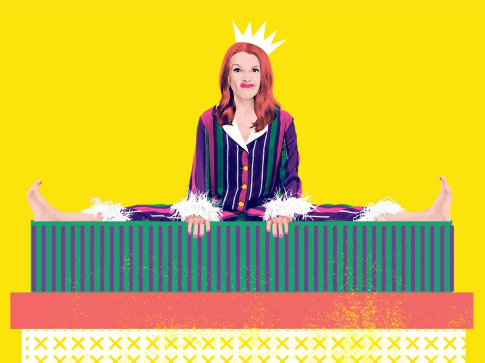 A person with red hair sits in a splits position on a platform, wearing a striped outfit with fuzzy cuffs, and a white crown on a yellow background.