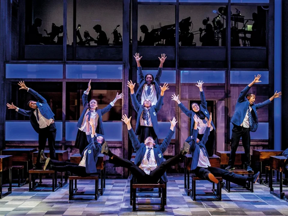 Production shot of Everybody's Talking About Jamie in San Francisco, showing ensemble dancing on chairs.