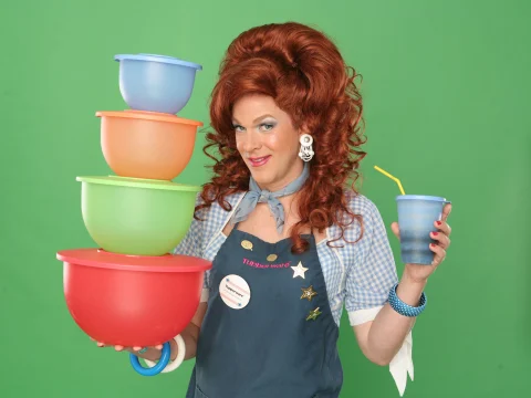 Production shot of Dixie's Tupperware Party with Dixie holding tupperwares.