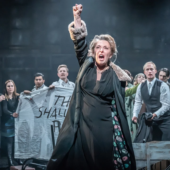Production image of The Merchant of Venice in London, featuring Tracy Ann Oberman as Shylock with ensemble cast.