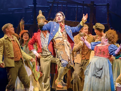 Production shot of Les Misérables in London, with Gerard Carey as Thénardier and Claire Machin as Madame Thénardier.