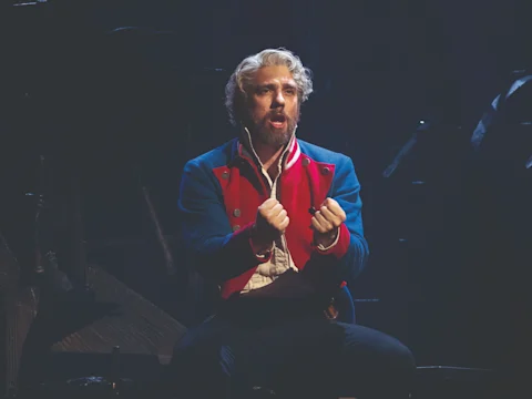 Production shot of Les Misérables in London, with Gerard Carey as Thénardier and Claire Machin as Madame Thénardier.