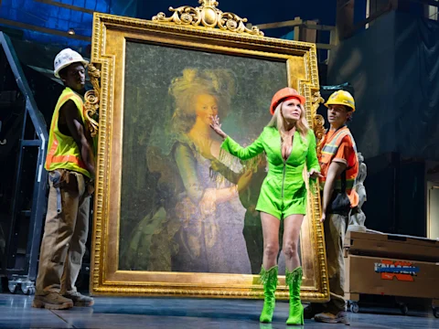Production shot of The Queen of Versailles in New York, with Kristin Chenoweth as Jackie Siegel in a bright green outfit.