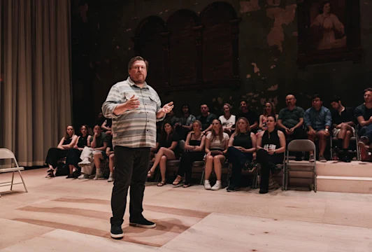 Production image of Michael Chernus on stage.