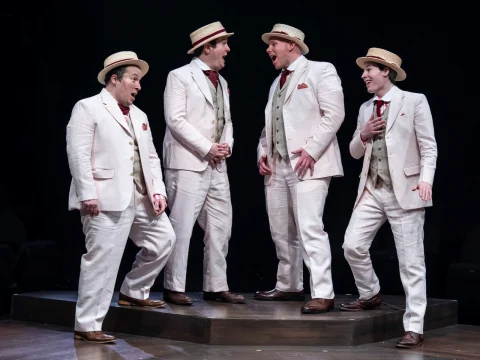 Production shot of Meredith Willson's The Music Man in Chicago, showing men singing.