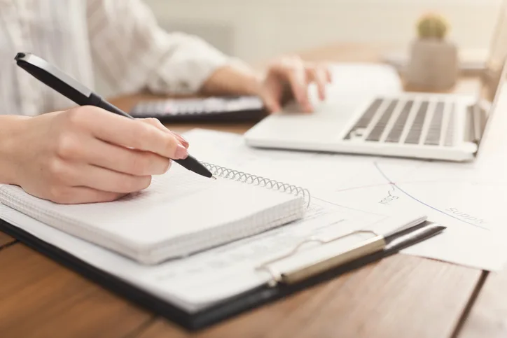 Woman's hand writing in journal.