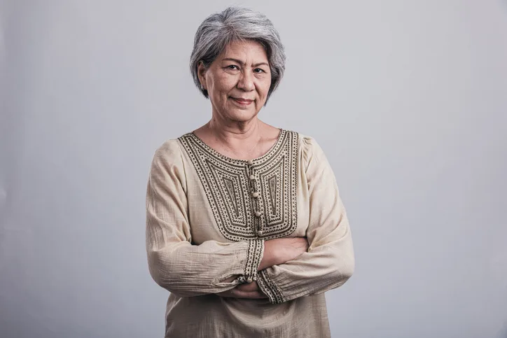 Happy Senior woman portrait in grey background