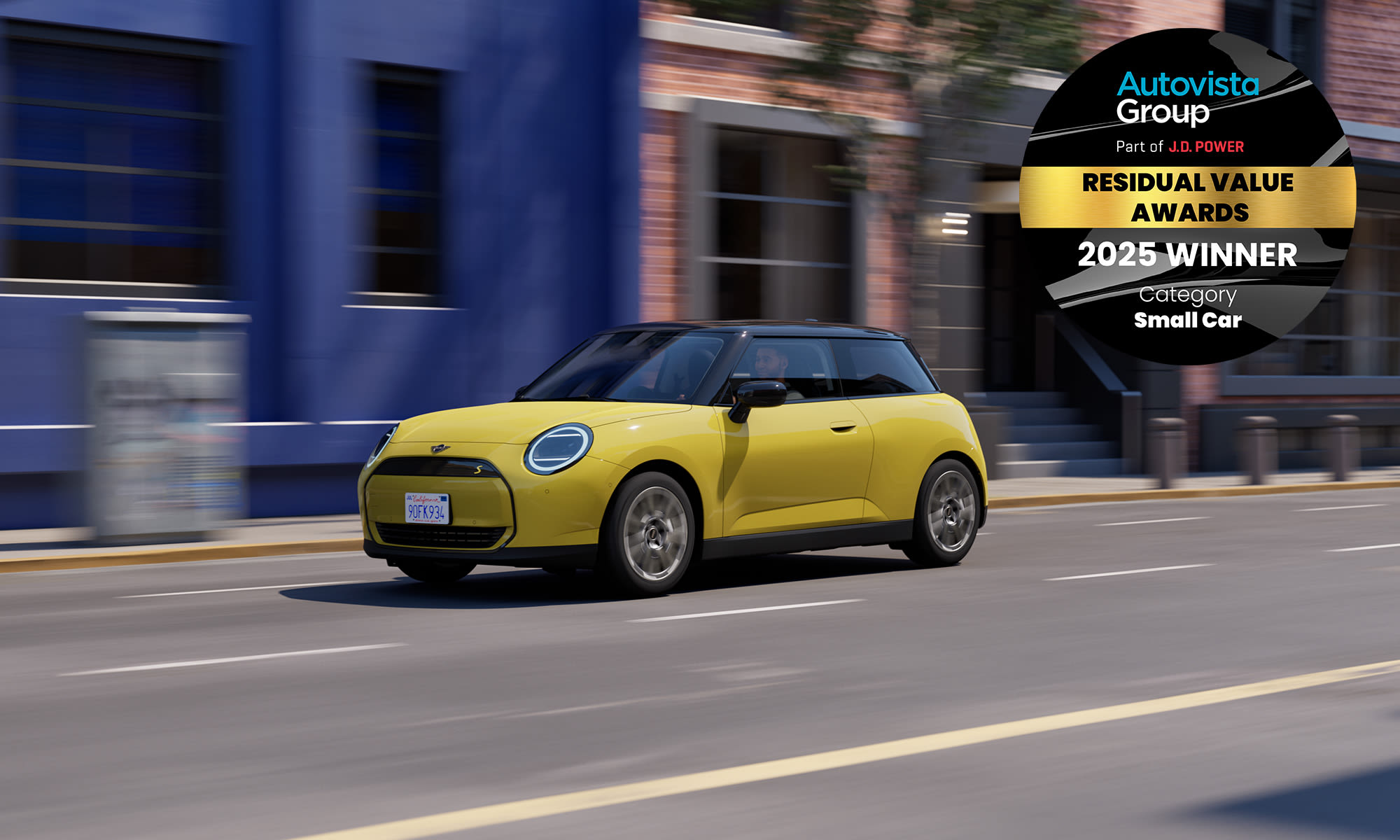 Yellow MINI in motion on a city street, shown with a 2025 award winner badge.