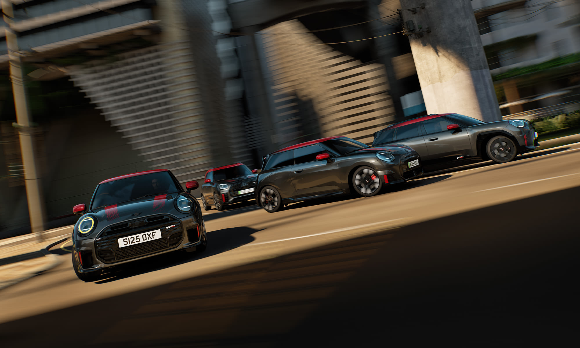Four MINI John Cooper Works cars driving together through an urban overpass.