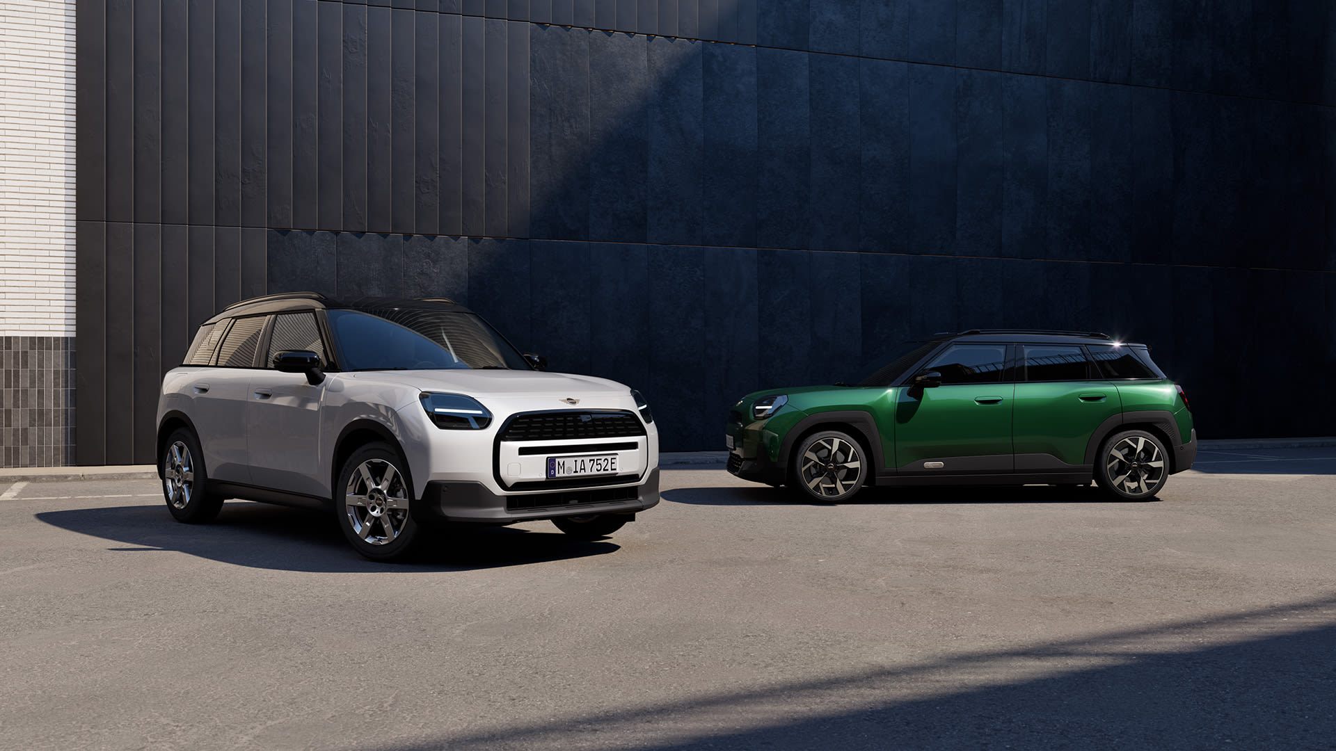 White and green MINI SUVs parked side by side in an urban setting.