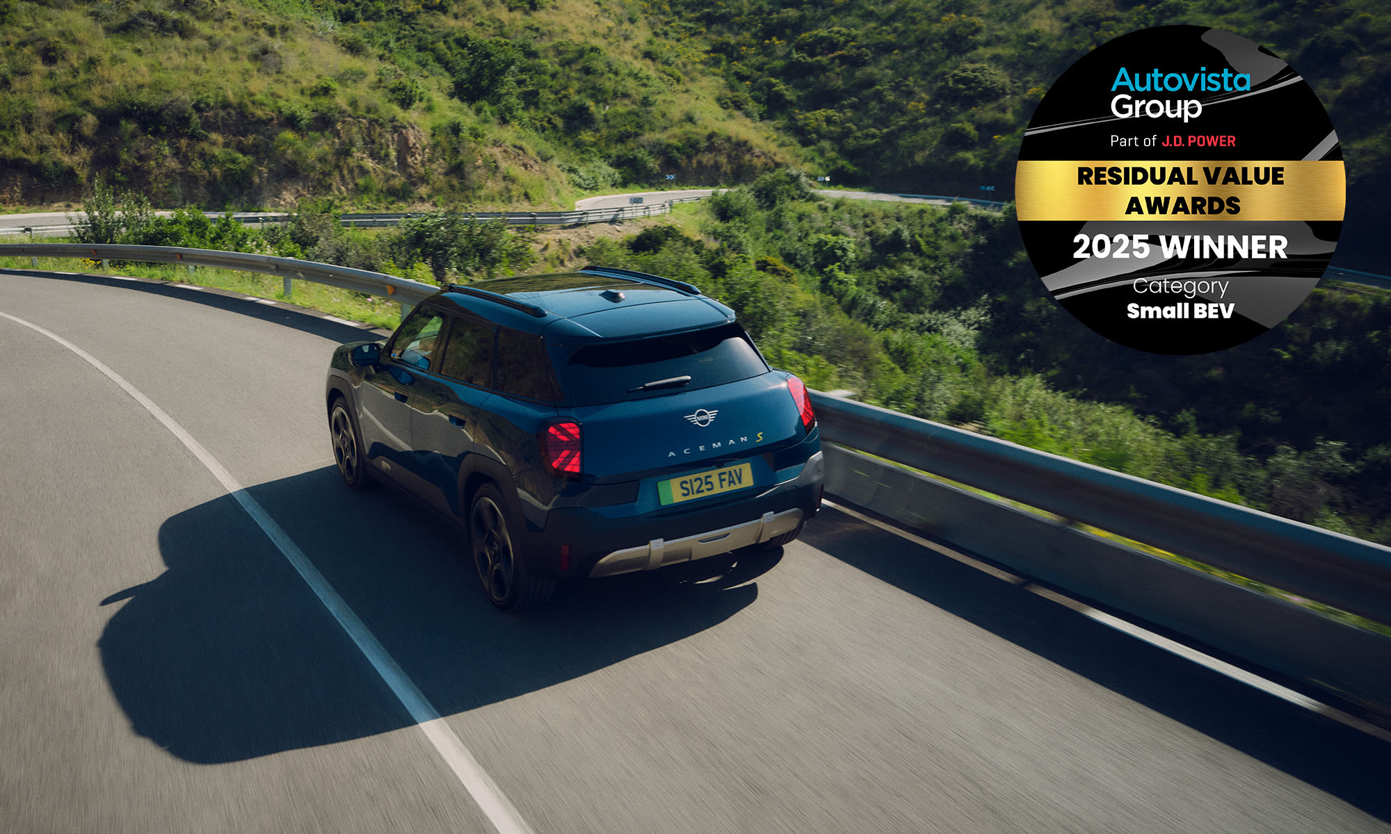Rear view of a MINI Aceman driving on a road, highlighting a 2025 industry award win.