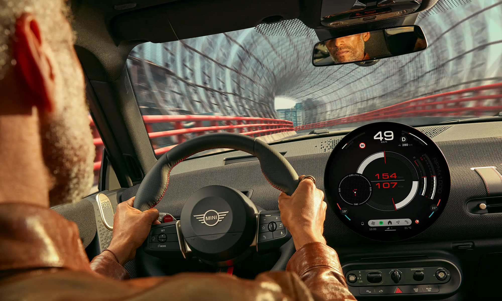 View from inside a MINI John Cooper Works showing the driver’s perspective and digital instrument display while driving.