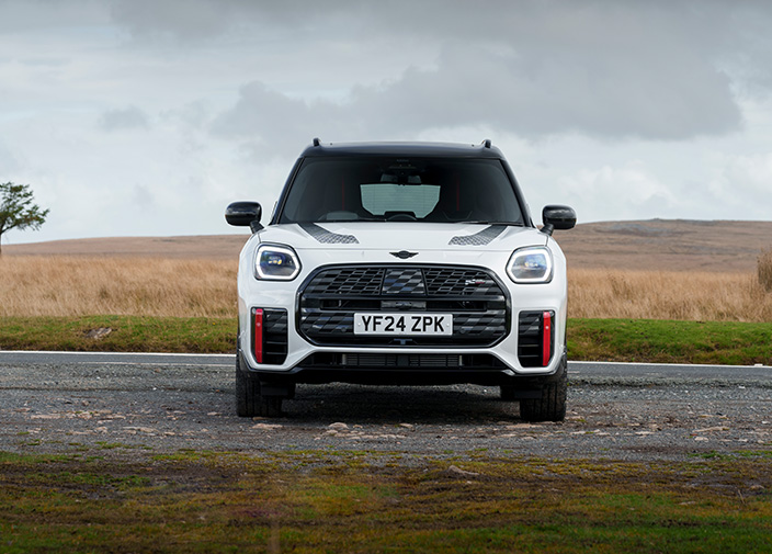 White MINI Countryman facing forward parked in a field